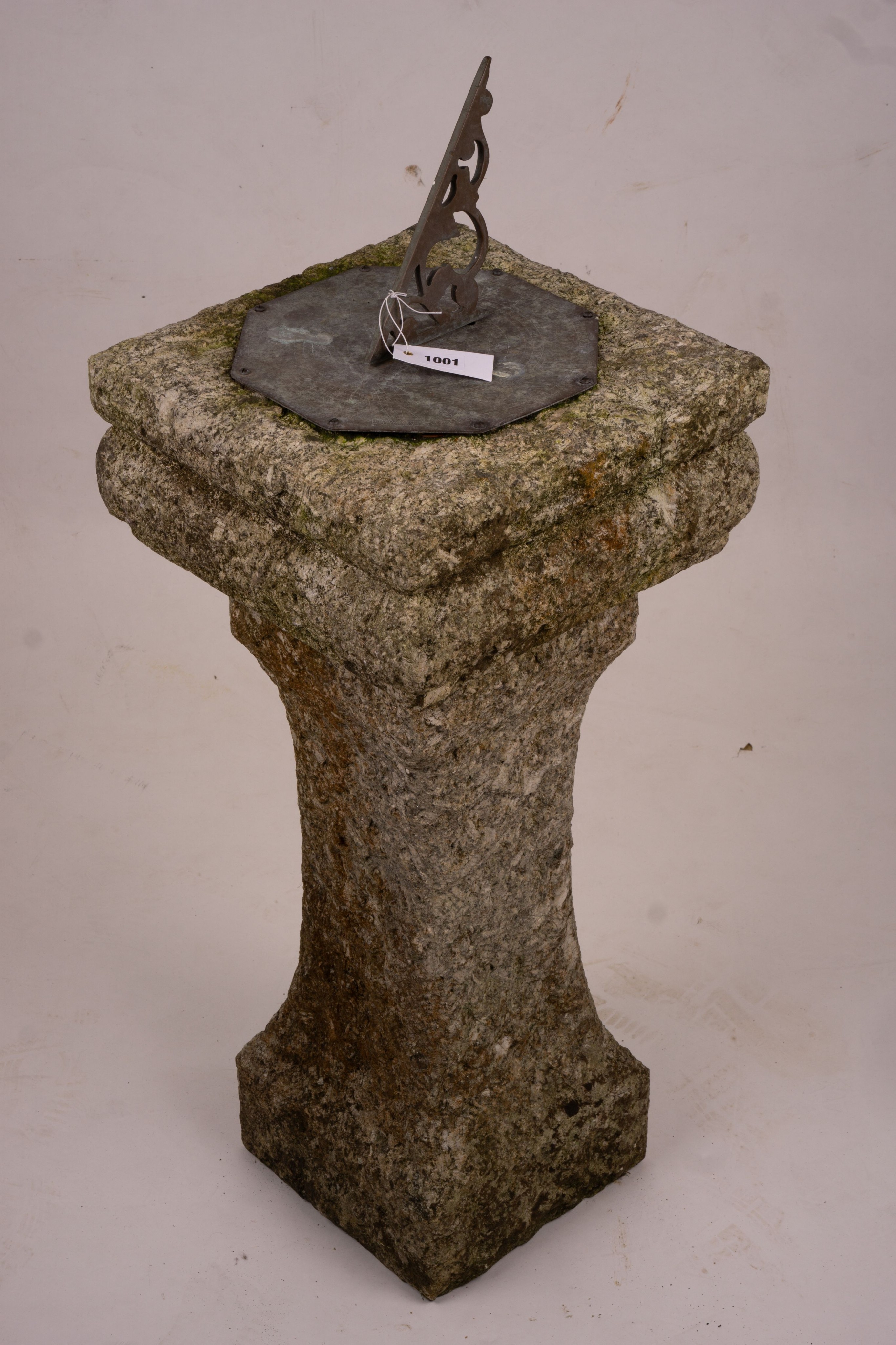 An octagonal sundial on reconstituted stone plinth, height 92cm